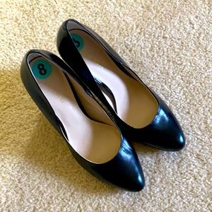 Black leather heels with gold detail